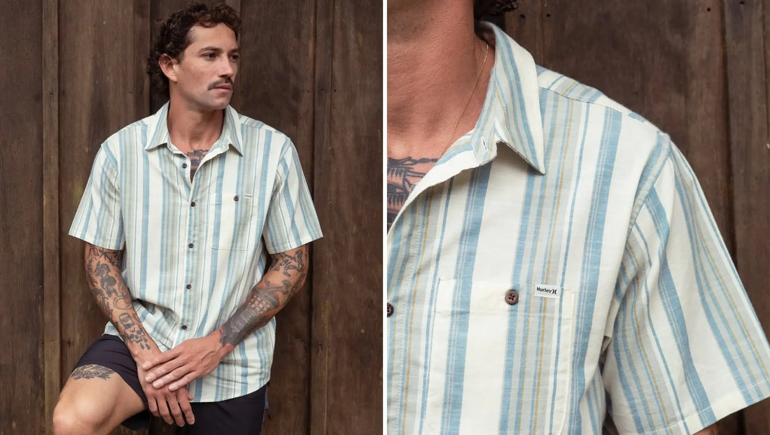 Modelo em fundo amadeirado vestindo a camisa manga curta listrada off white listrada Hurley ONE&ONLY Lido Stripe.