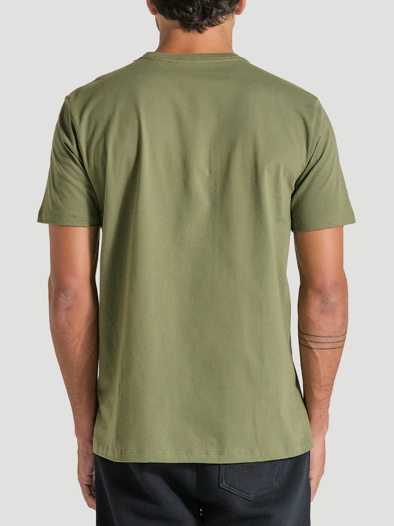 Homem vestindo camiseta verde militar estampada, vista de costas. A camiseta é lisa e possui modelagem reta.
