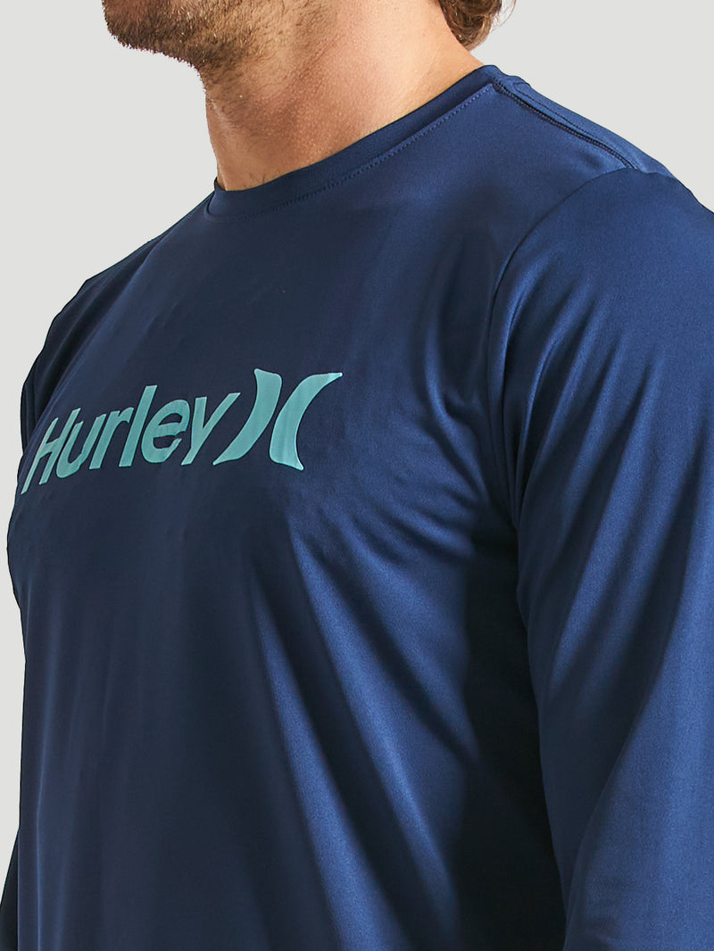 Lycra surf manga longa azul marinho, com logo Hurley azul claro no peito. Tecido ajustado e confortável, ideal para proteção.